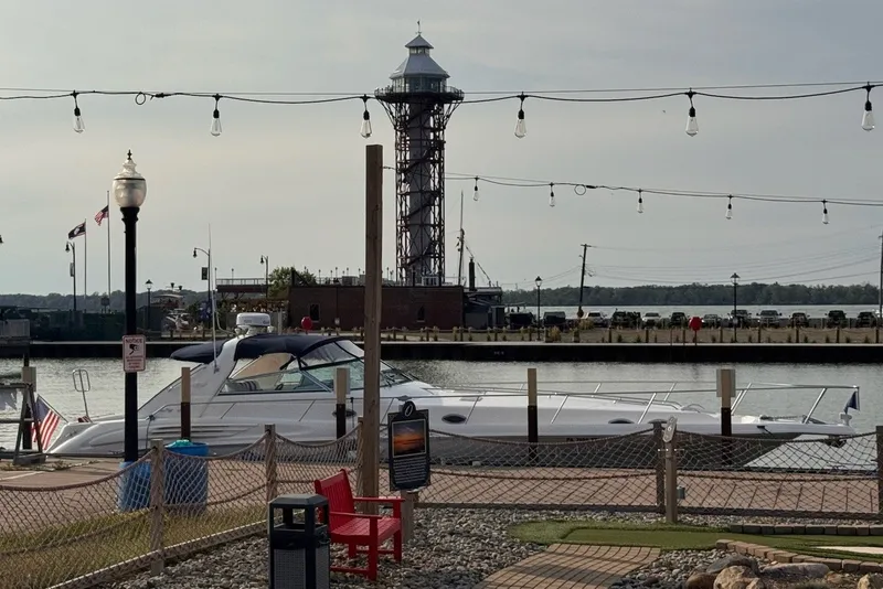 The Image of A 1997 Sea Ray 450 Sundancer docked with a lighthouse in the background. - 2