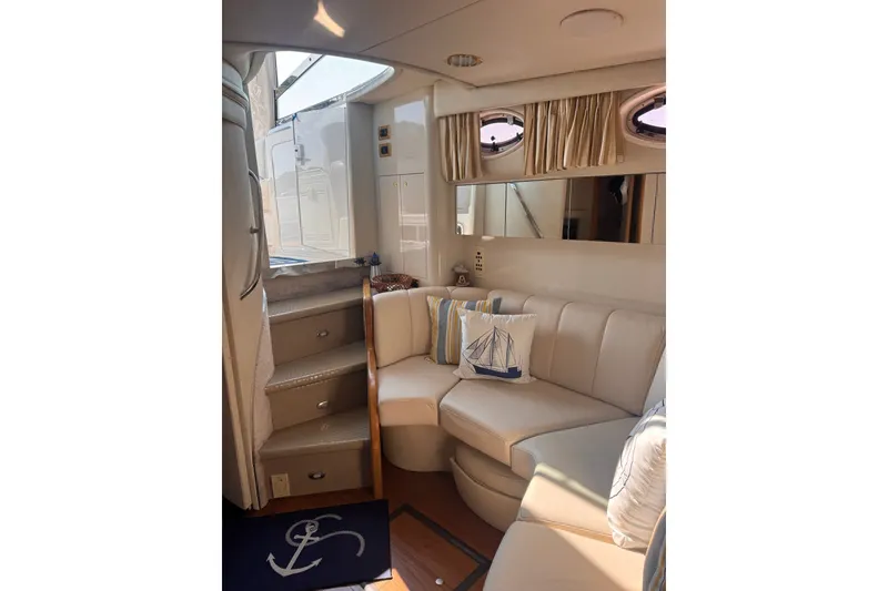 Slide: The Image of Interior of 1997 Sea Ray 450 Sundancer yacht with beige seating and nautical decor. - 25