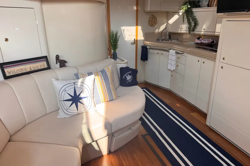 Slide: The Image of Interior of 1997 Sea Ray 450 Sundancer yacht with cozy seating and nautical decor. - 28
