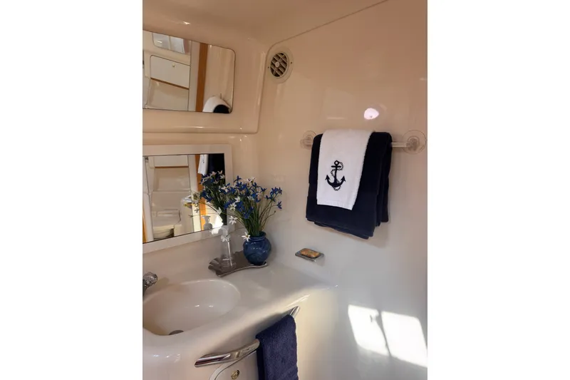 Slide: The Image of Bathroom interior of 1997 Sea Ray 450 Sundancer yacht with nautical-themed decor. - 39