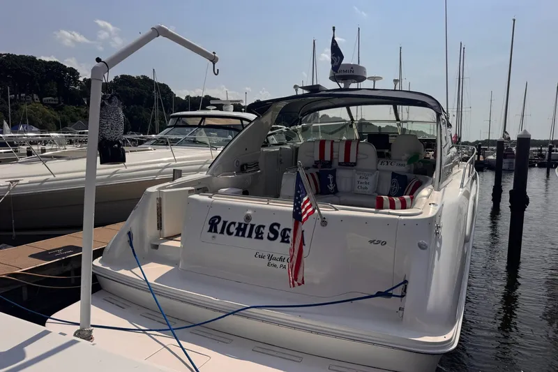 Slide: The Image of 1997 Sea Ray 450 Sundancer yacht docked at marina with American flag. - 1