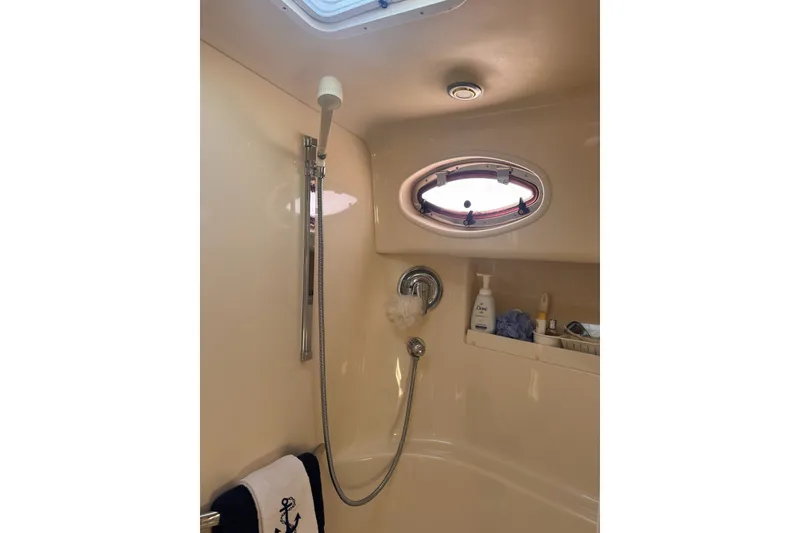 Slide: The Image of Shower area in 1997 Sea Ray 450 Sundancer yacht with porthole and toiletries. - 37