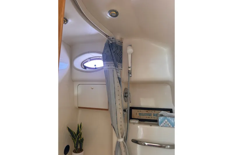 Slide: The Image of Interior of 1997 Sea Ray 450 Sundancer yacht bathroom with shower and porthole window. - 41