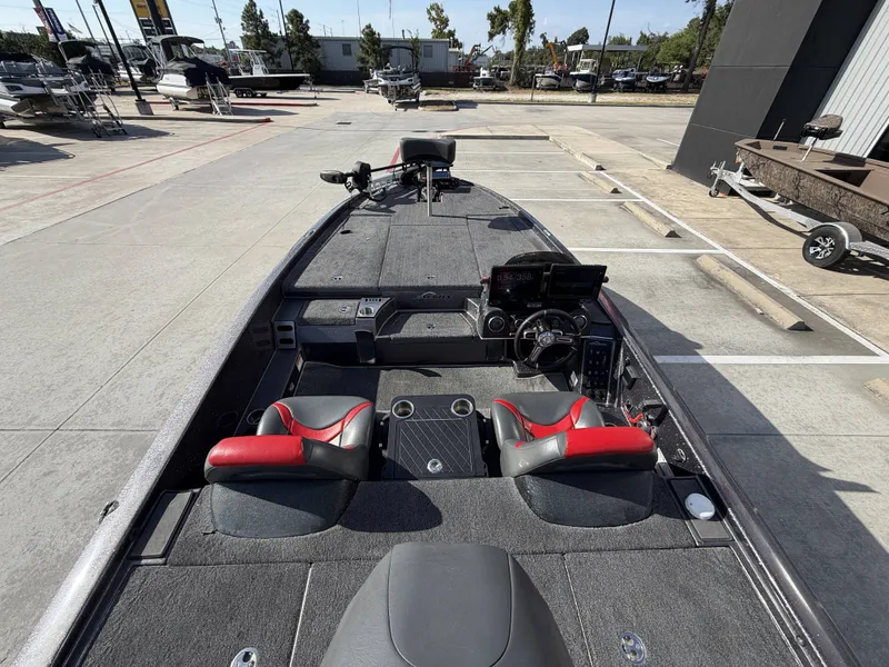 Slide: The Image of The image shows a 2018 Falcon F205 boat with a gray deck and red seats. - 13