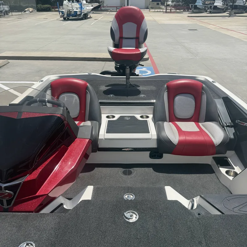 Slide: The Image of The image shows a 2019 Ranger Z518 boat with red and gray seating. - 18