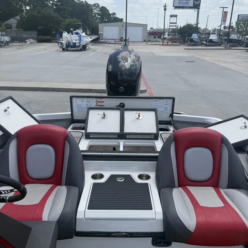 Slide: The Image of The image shows the cockpit of a 2019 Ranger Z518 boat with red and gray seats. - 20