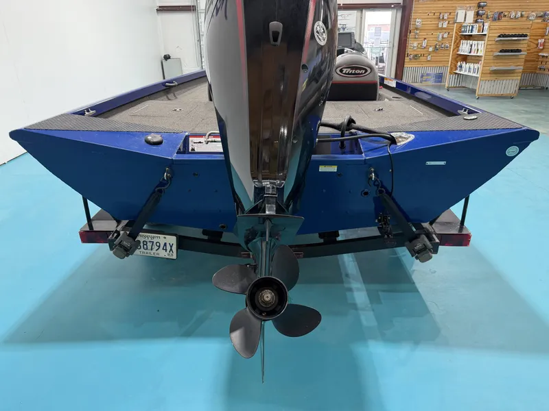 Slide: The Image of A blue 2017 Triton 18CTX is in a showroom. The outboard motor is visible. - 20