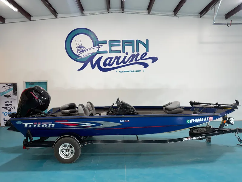 The Image of A blue 2017 Triton 18CTX sits on a trailer in a showroom. - 1