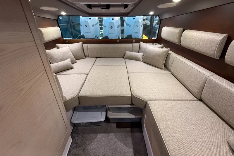 Slide: The Image of Luxurious interior of 2024 Axopar 45 XC Cross Cabin with beige seating and cushions. - 24