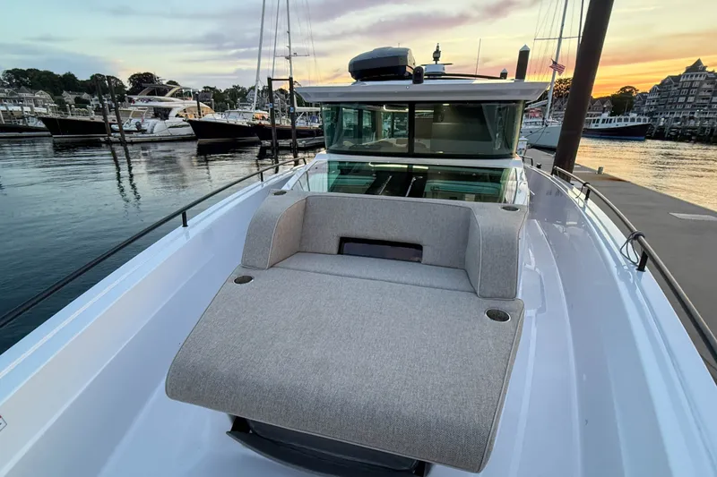 Slide: The Image of 2024 Axopar 45 XC Cross Cabin boat at sunset in marina. - 11