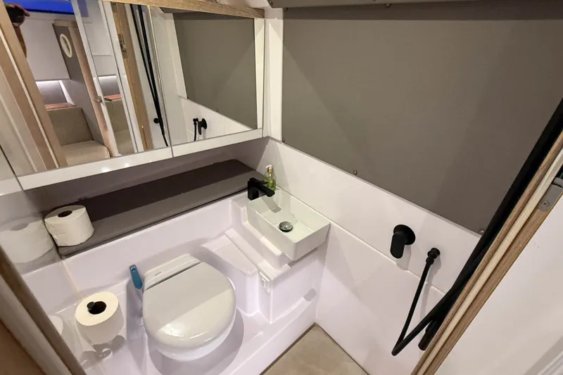 Slide: The Image of Modern bathroom in 2024 Axopar 45 XC Cross Cabin boat, featuring compact design and amenities. - 41