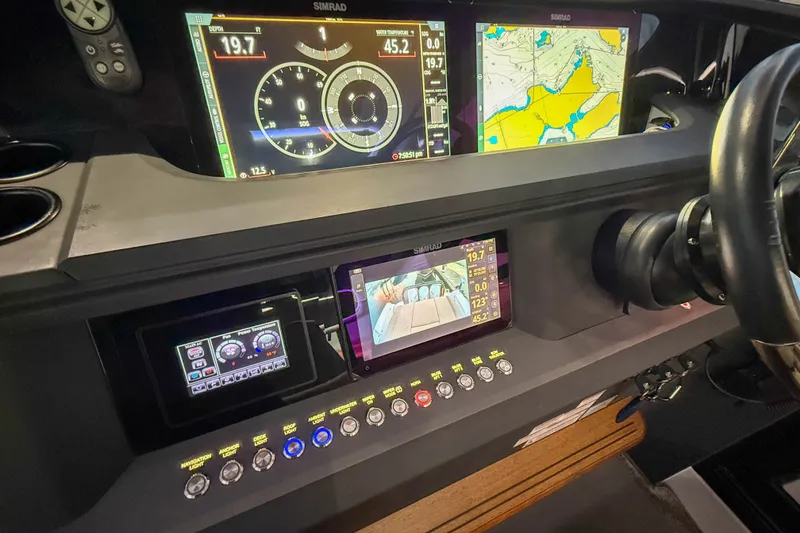 Slide: The Image of Dashboard of 2024 Axopar 45 XC Cross Cabin with navigation and control displays. - 33