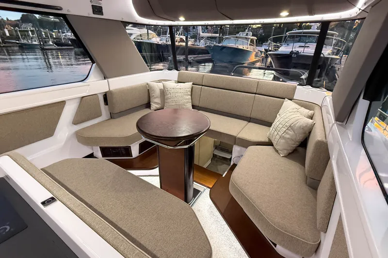 Slide: The Image of Luxurious interior of 2024 Axopar 45 XC Cross Cabin with plush seating and elegant table. - 19