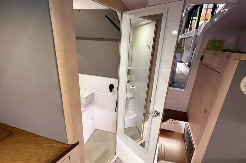Slide: The Image of Interior of 2024 Axopar 45 XC Cross Cabin, featuring a compact bathroom with modern amenities. - 39