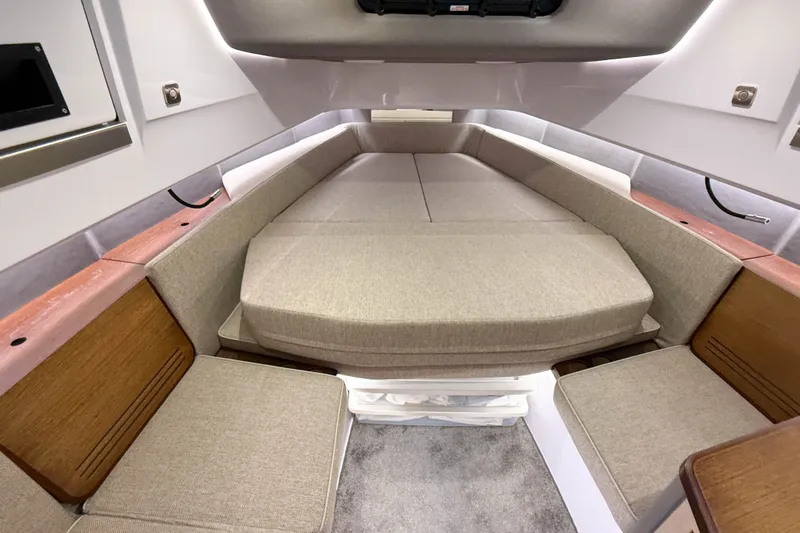 Slide: The Image of 2024 Axopar 45 XC Cross Cabin interior with beige seating and wooden accents. - 37