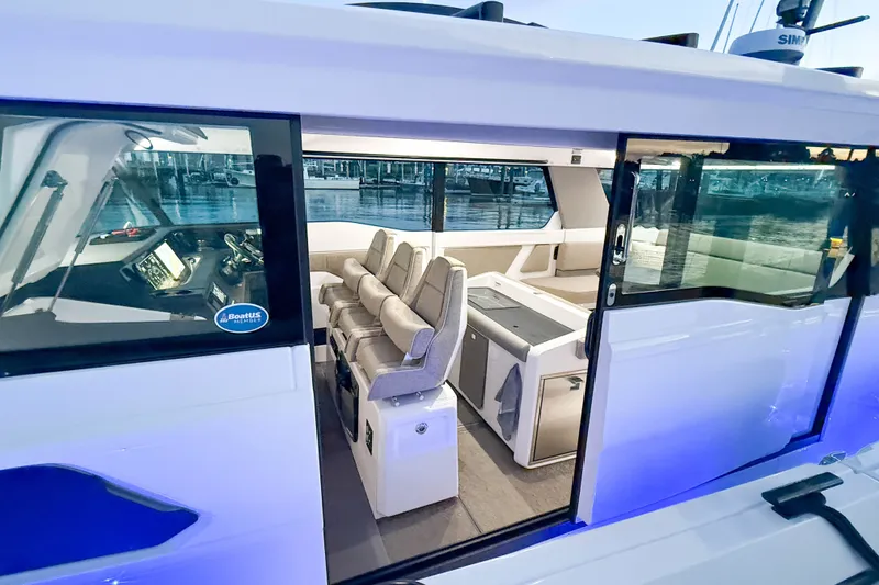 Slide: The Image of 2024 Axopar 45 XC Cross Cabin interior with modern seating and navigation controls. - 15