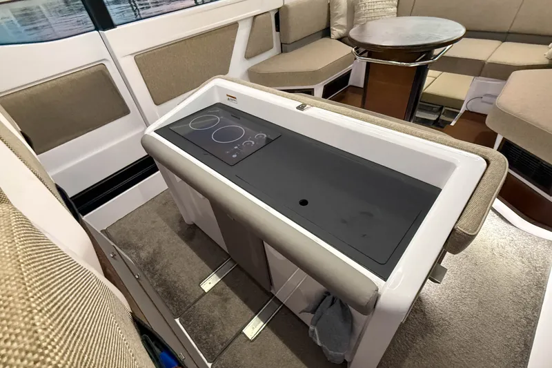 Slide: The Image of Interior of 2024 Axopar 45 XC Cross Cabin with modern kitchenette and seating area. - 17
