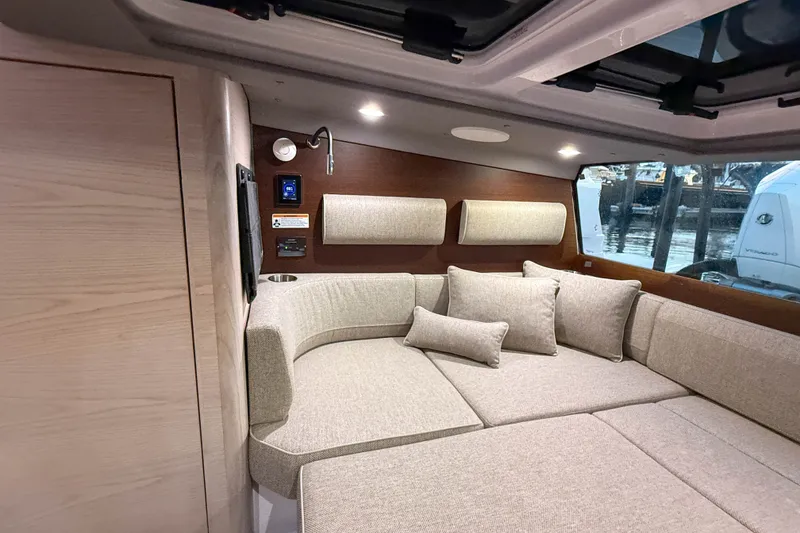 Slide: The Image of 2024 Axopar 45 XC Cross Cabin interior with cozy seating and modern design. - 26