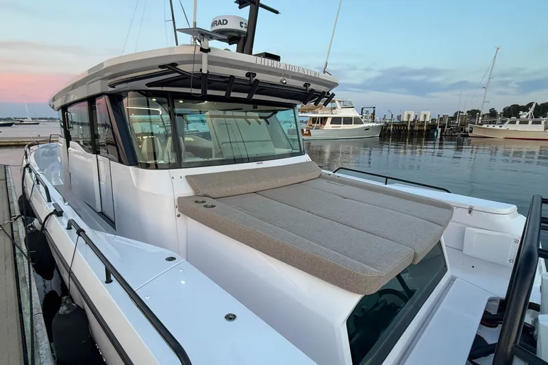 Slide: The Image of 2024 Axopar 45 XC Cross Cabin boat docked at marina during sunset. - 5