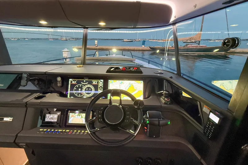 Slide: The Image of Interior view of 2024 Axopar 45 XC Cross Cabin boat cockpit with advanced navigation displays. - 31