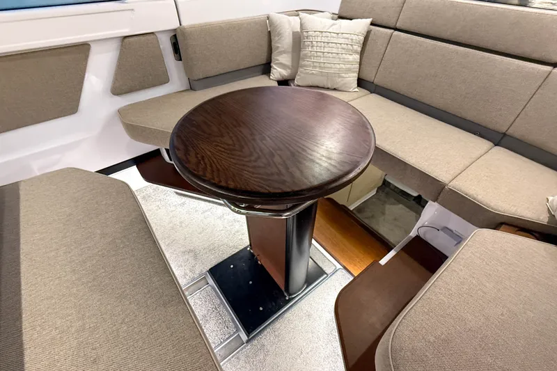 Slide: The Image of Luxurious seating area in 2024 Axopar 45 XC Cross Cabin with elegant wooden table. - 20