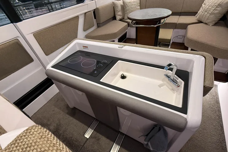 Slide: The Image of Modern interior of 2024 Axopar 45 XC Cross Cabin with kitchenette and seating area. - 18