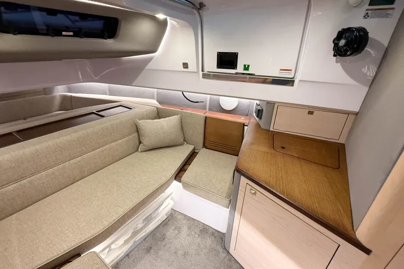 Slide: The Image of Interior of 2024 Axopar 45 XC Cross Cabin with beige seating and wooden accents. - 38