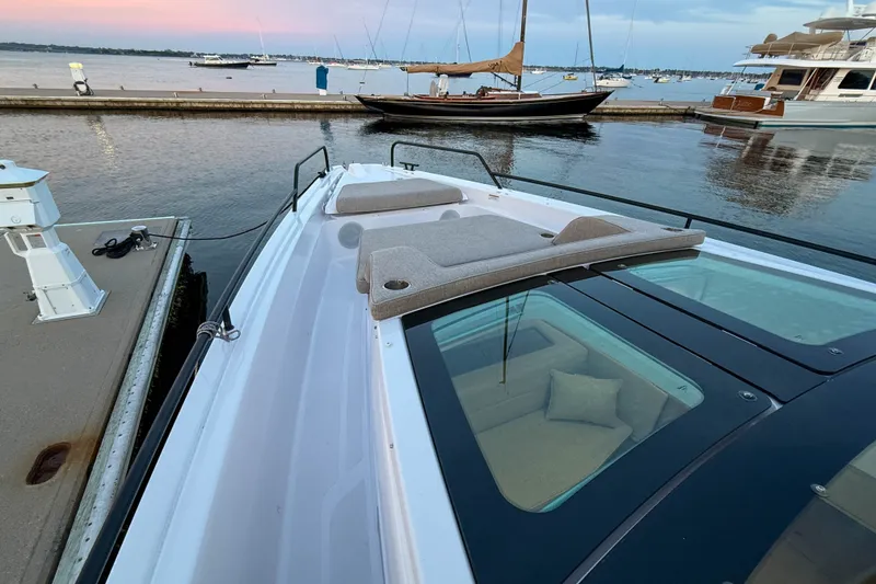 Slide: The Image of 2024 Axopar 45 XC Cross Cabin docked, showcasing sleek design and spacious deck. - 14