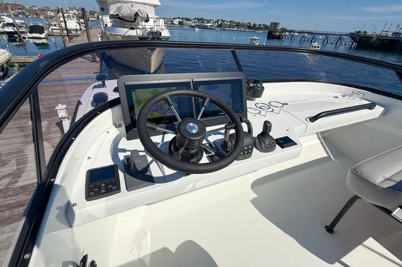 Slide: The Image of Helm of 2026 Targa 41 boat with advanced navigation systems, docked at marina. - 15