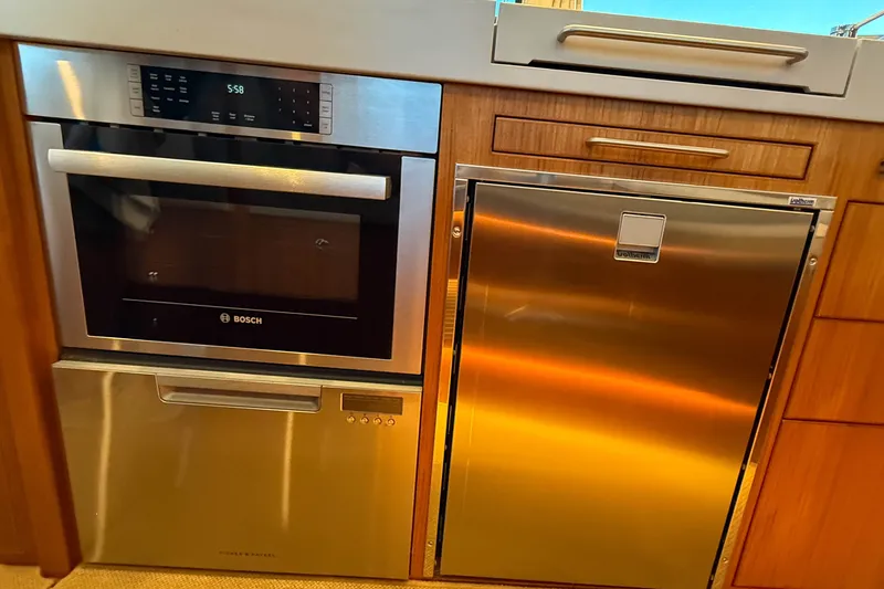 Slide: The Image of Modern kitchen appliances in a Targa 41 yacht, featuring Bosch oven and stainless steel finishes. - 23