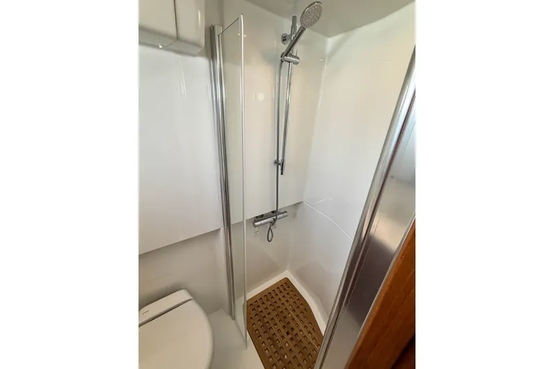 Slide: The Image of Modern shower area in 2026 Targa 41 boat, featuring sleek design and wooden floor mat. - 42