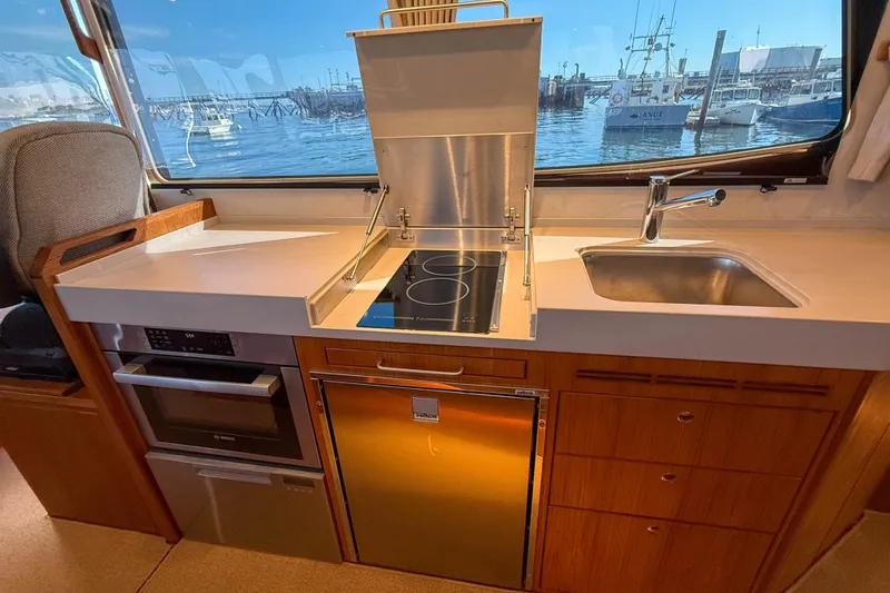 Slide: The Image of Modern kitchen in 2026 Targa 41 yacht with stove, sink, and ocean view. - 24