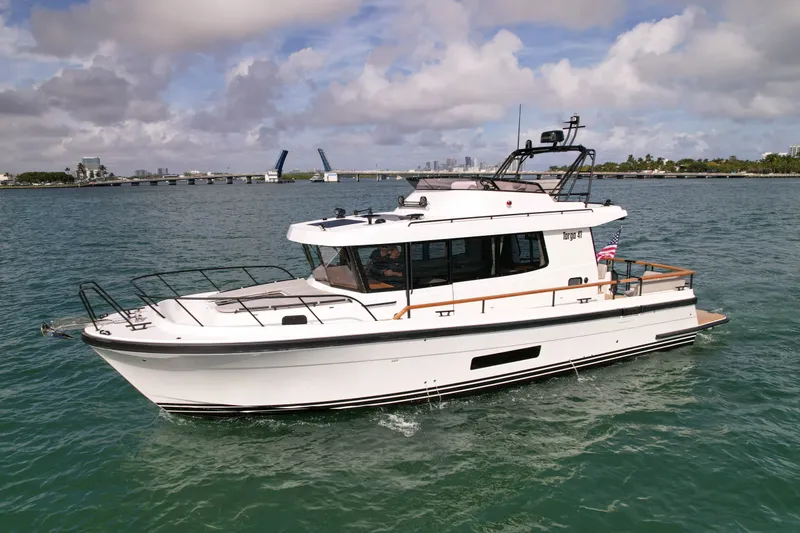 The Image of 2026 Targa 41 boat cruising on a sunny day near a bridge. - 0