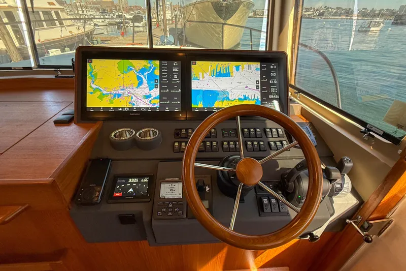 Slide: The Image of Helm of 2026 Targa 41 boat with dual navigation screens and wooden steering wheel. - 32