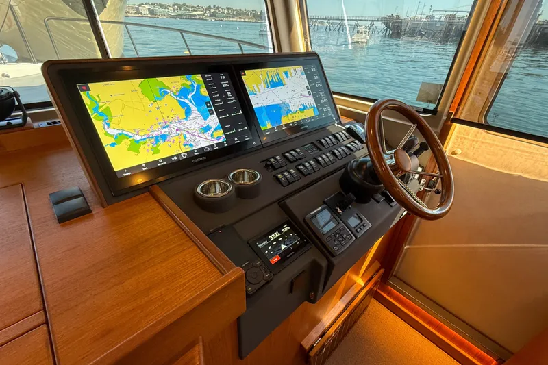 Slide: The Image of Helm of 2026 Targa 41 boat with dual navigation screens and wooden steering wheel. - 31