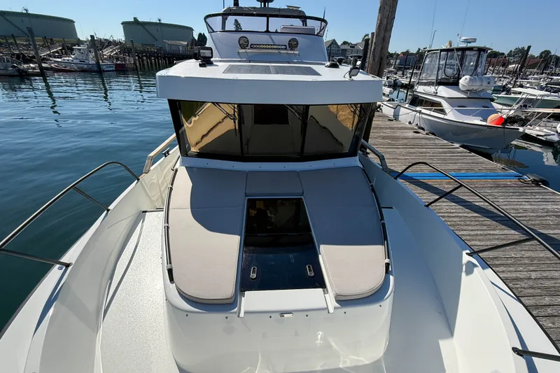 Slide: The Image of 2026 Targa 41 boat docked at marina, showcasing sleek design and spacious deck. - 55