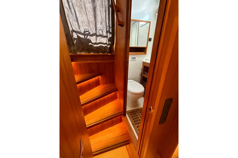 Slide: The Image of Interior of 2026 Targa 41 yacht featuring wooden stairs and compact bathroom. - 51