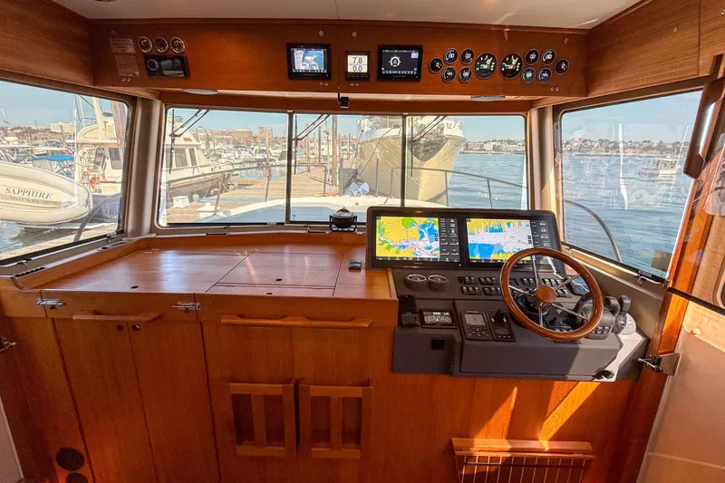 Slide: The Image of 2026 Targa 41 boat cockpit with navigation screens and wooden steering wheel. - 29