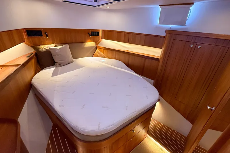 Slide: The Image of Luxurious cabin interior of 2026 Targa 41 yacht with cozy bed and wooden finish. - 38