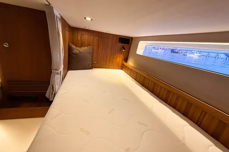 Slide: The Image of Luxurious cabin interior of 2026 Targa 41 yacht with a comfortable bed and scenic window view. - 50