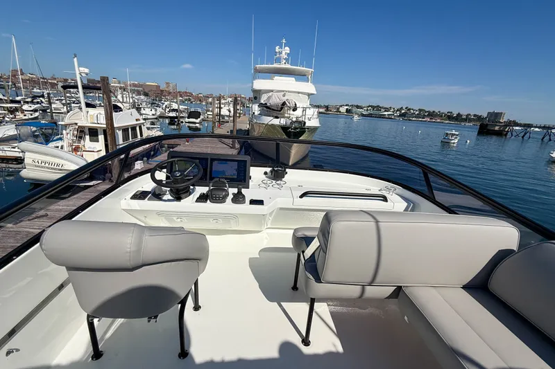 Slide: The Image of Flybridge view of 2026 Targa 41 yacht docked in a marina under clear blue skies. - 14