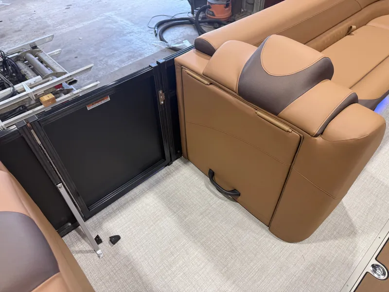 Slide: The Image of The image shows a luxurious brown leather seating area on a boat with a small black cabinet. - 29