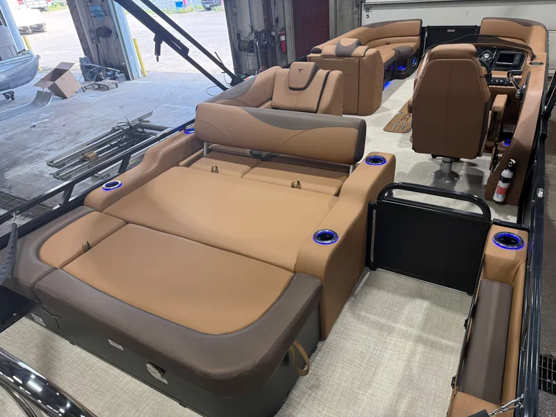 Slide: The Image of The image shows the interior of a Tahoe LTZ 300HP VRB 2385 Swingback Tritoon with luxurious brown seating. - 22