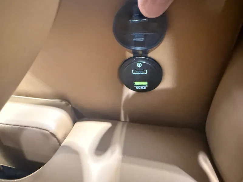 Slide: The Image of Close-up of a USB charging port in a boat with brown upholstery. - 27