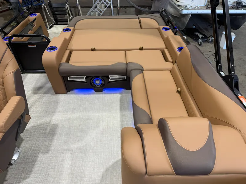 Slide: The Image of The image shows the luxurious interior of a Tahoe LTZ 300HP VRB 2385 Swingback Tritoon with beige upholstery. - 18