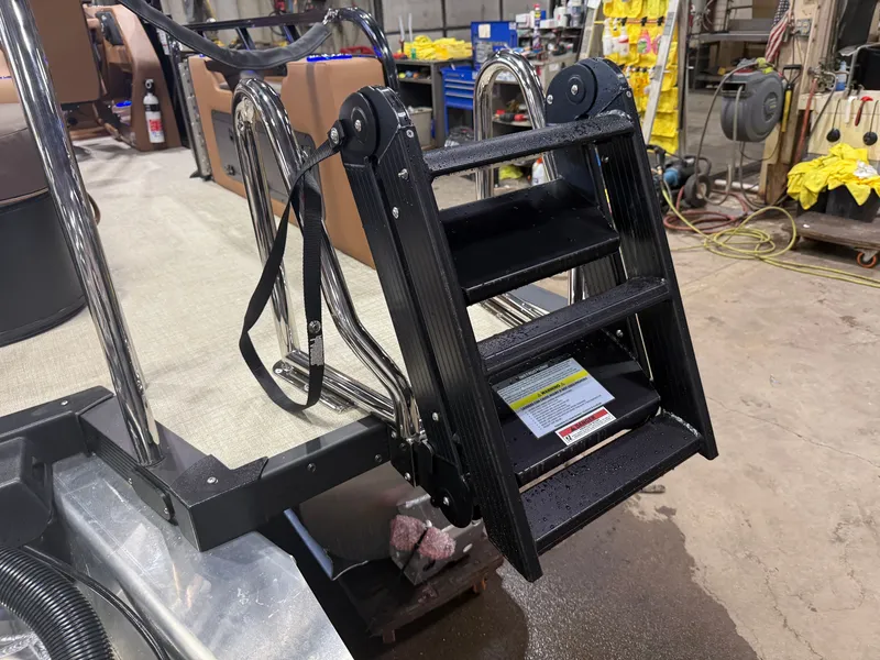Slide: The Image of A black boat ladder with non-slip steps is attached to a tritoon. - 47
