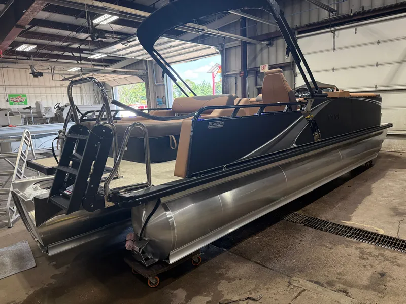 Slide: The Image of A modern tritoon with sleek seating and a sturdy frame in a warehouse setting. - 49