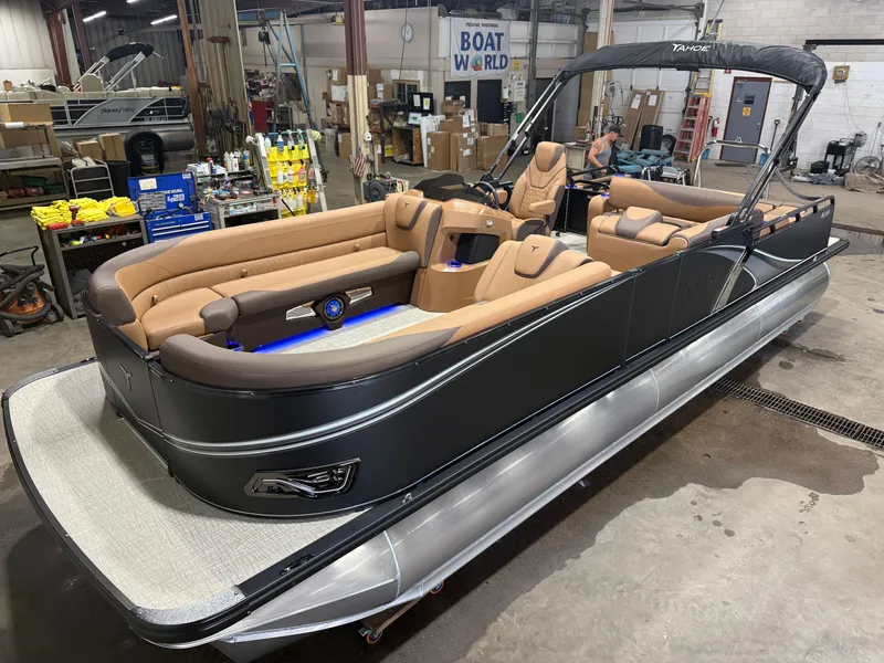 The Image of A luxurious tritoon boat with sleek brown seating and modern design, situated in a workshop. - 1
