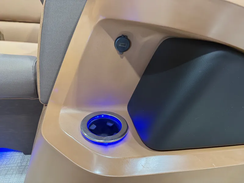 Slide: The Image of Close-up of a boat interior featuring a lit cup holder and a power outlet. - 34
