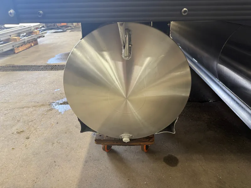 Slide: The Image of Close-up of a shiny metal cylinder, likely part of a boat, on a wheeled cart. - 44